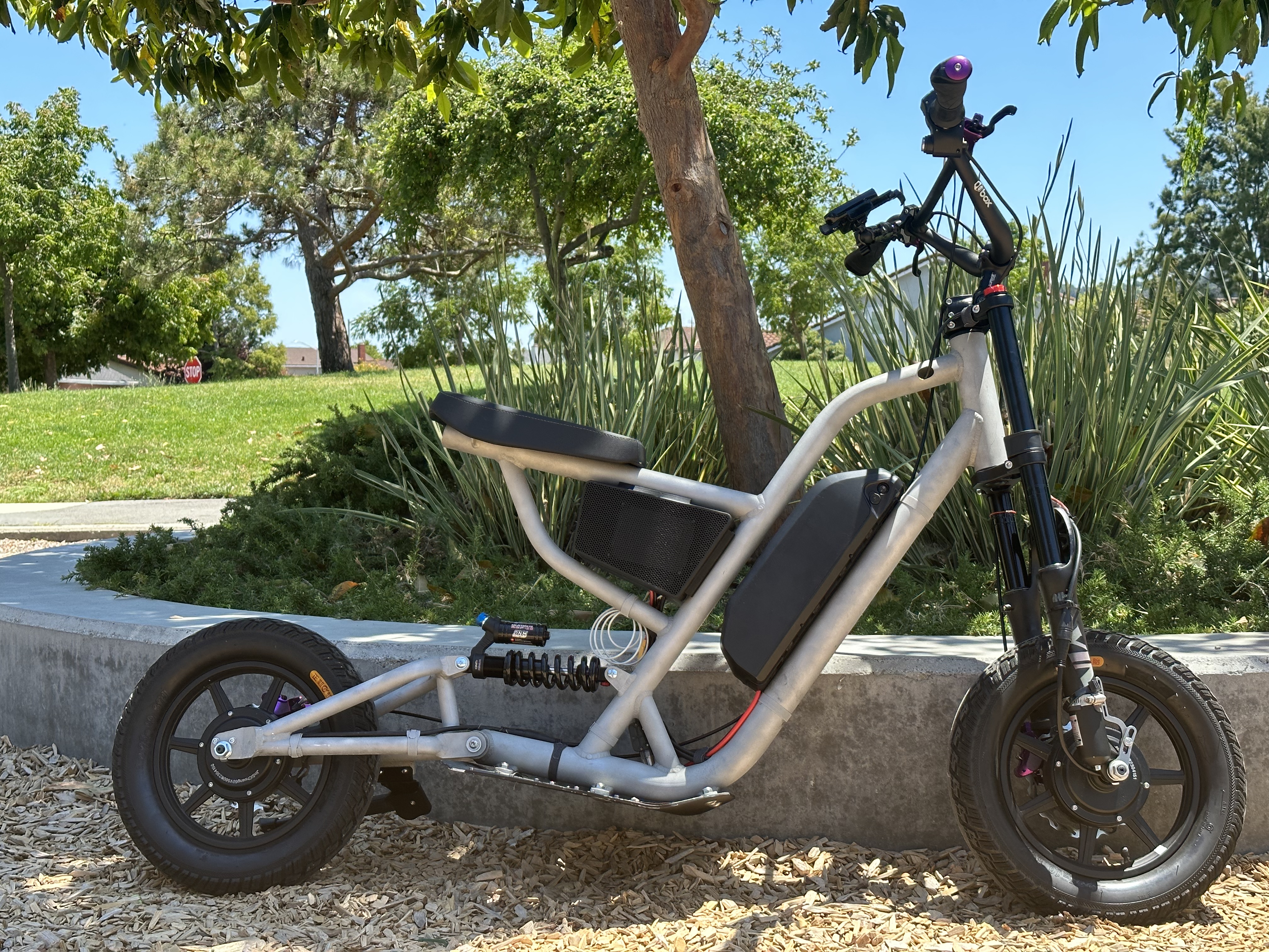 The &ldquo;bike&rdquo; propped up on a tree planter